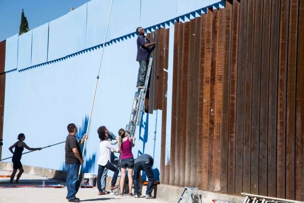 $!Artist Ana Teresa Fernndez, far left, with local and some Arizonians paint the fence in blue color the theme called Erasing the Border in Nogales Sonora, Mexico on October 13, 2015.